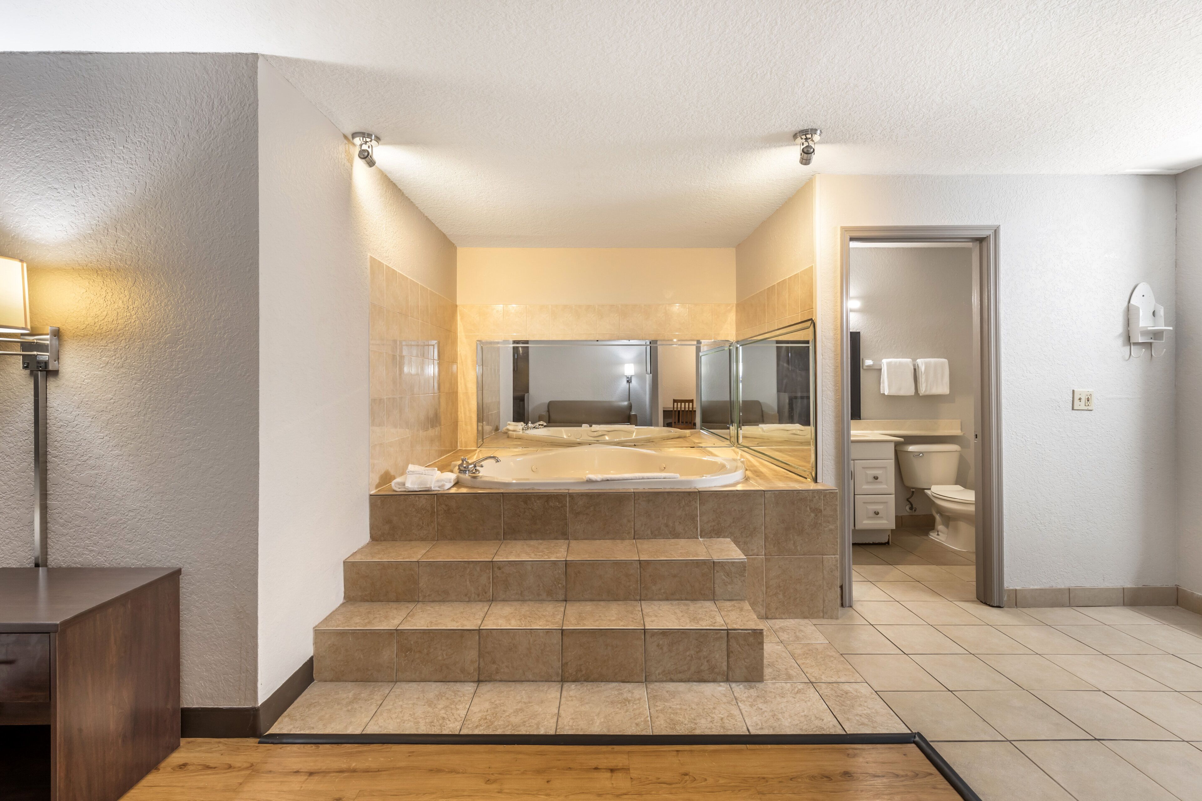 A modern bathroom with a freestanding bathtub, a walk-in shower, and a toilet.