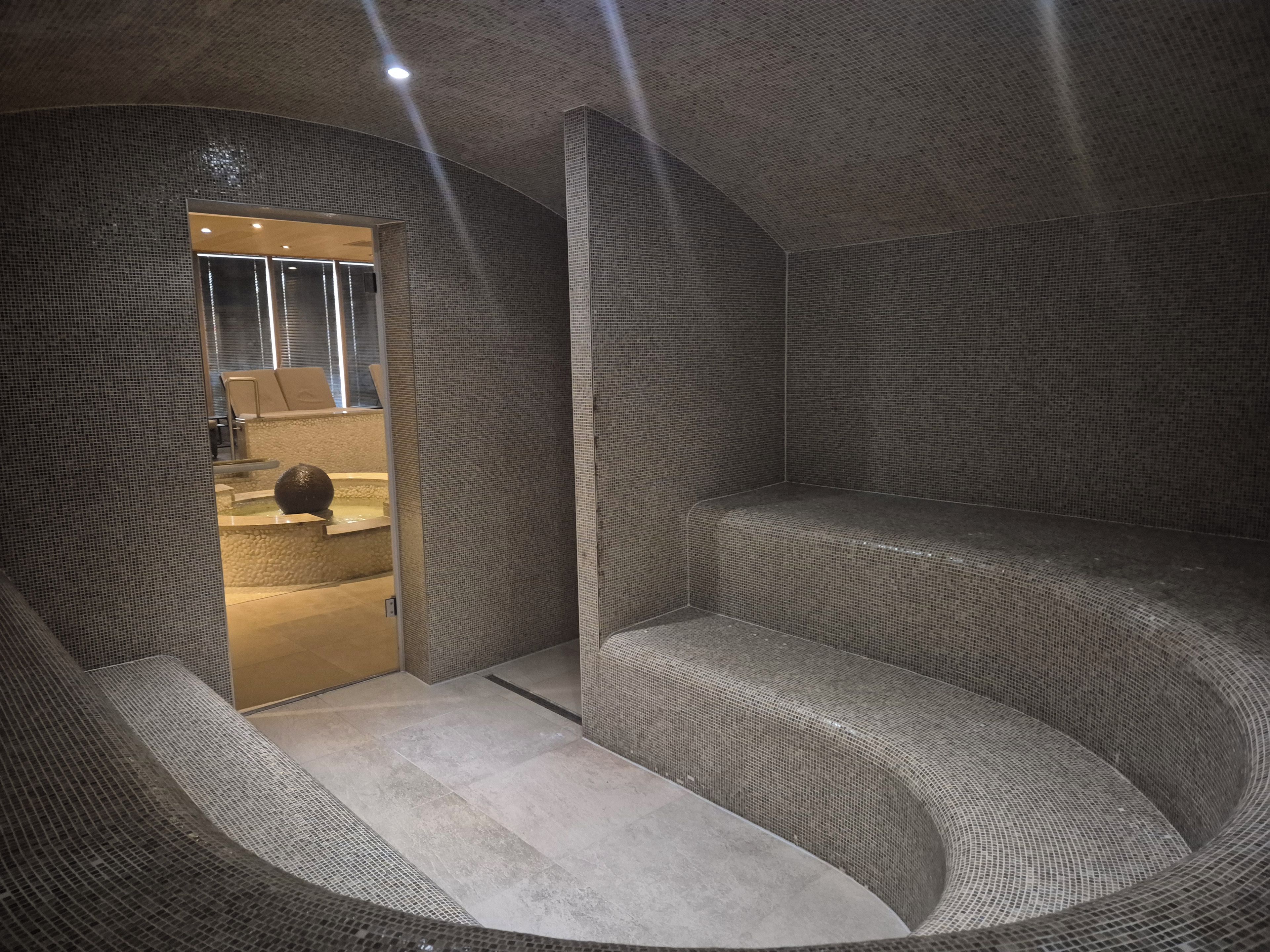 A modern interior with a curved seating area and a visible entrance to a bathroom.