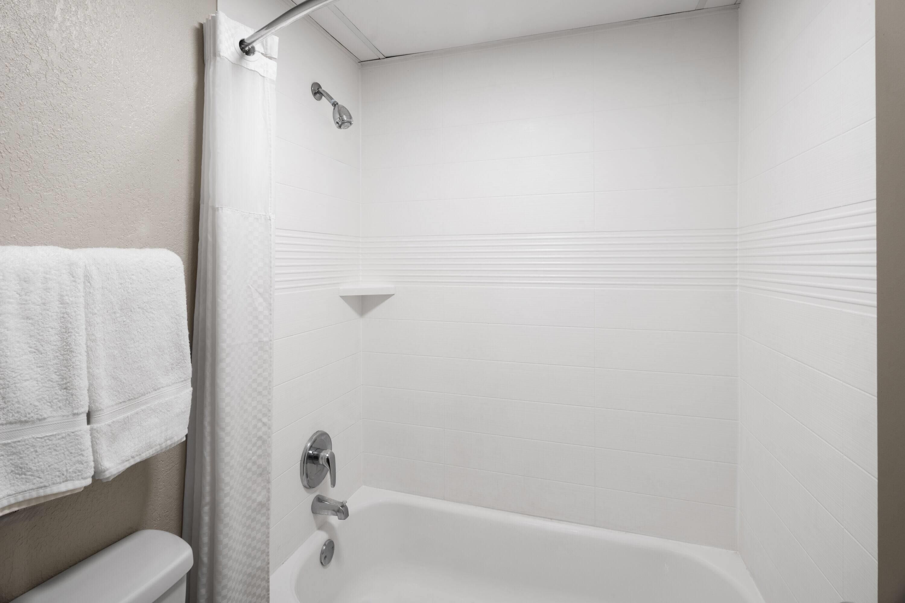 A bathroom with a bathtub, a shower, and a toilet.