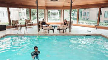 Relax by the pool with a clear view of the surrounding landscape, surrounded by lounge chairs and a table.