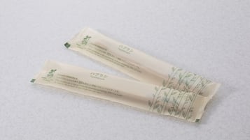 Two packages of bamboo toothbrushes with eco-friendly bamboo handles and 35% rice husk content.