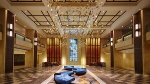 A spacious lobby with a checkered floor, a central seating area, and a large stained glass window. - Shinagawa Prince Hotel (Tokyo)