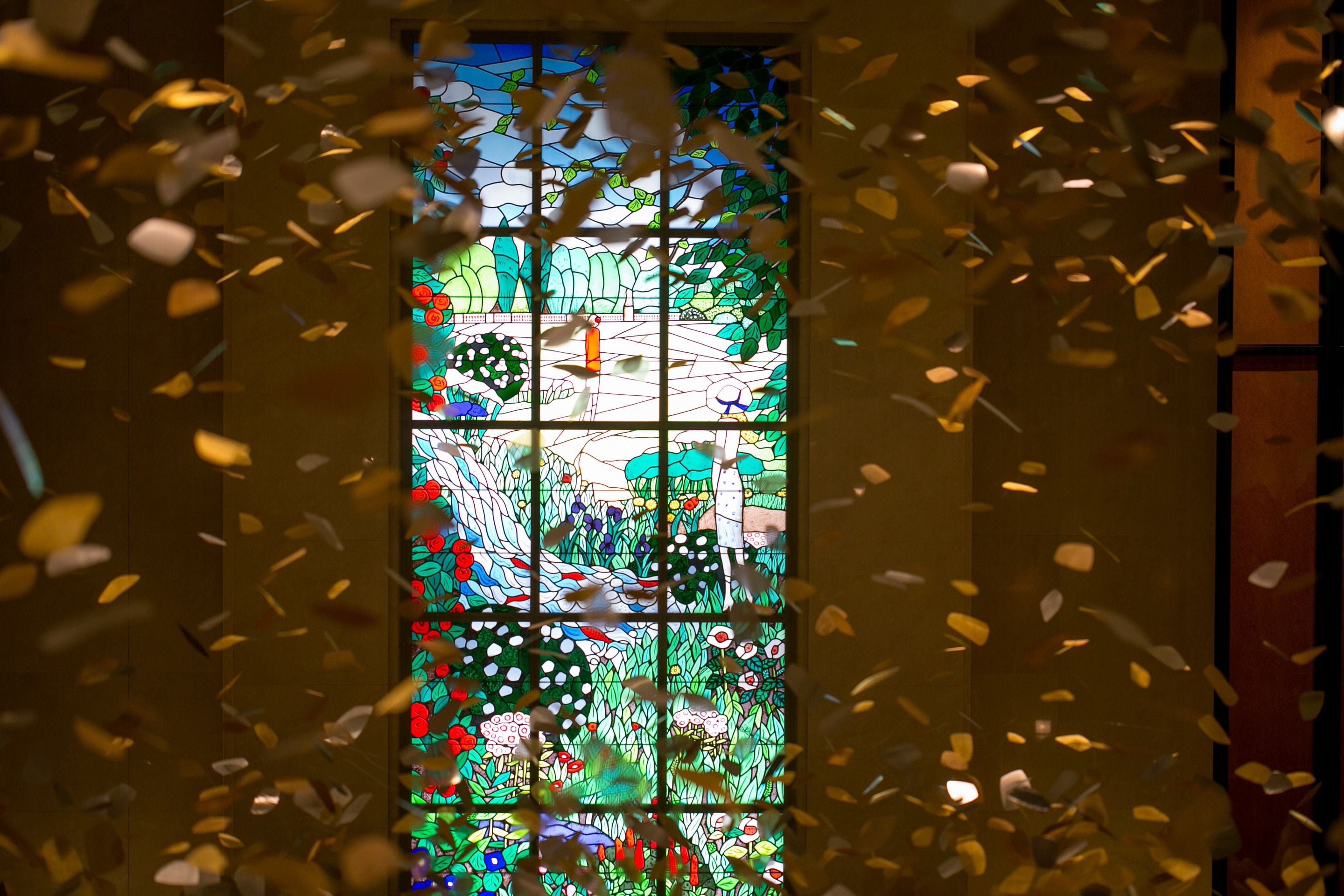 A stained glass window with a floral pattern.