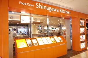 A food court named Shingagawa Kitchen with a glass display case and information boards.