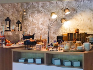 A buffet setup with various food items, baskets, and serving utensils.