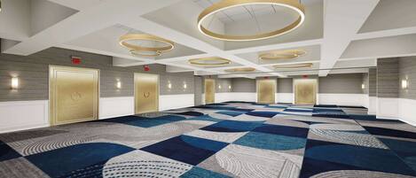 A spacious conference room with a patterned carpet, multiple doors, and modern circular ceiling lights.