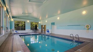 An indoor swimming pool with clear water, tiled walls, and a blue ceiling. - Best Western Cottage Grove Inn (Cottage Grove)