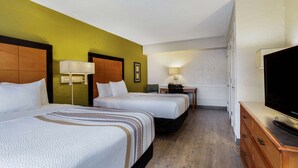 A hotel room with two beds, a desk, a TV, and a dresser. - La Quinta Inn Tampa Airport Stadium Westshore (Tampa)