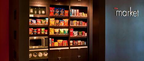 A vending machine with snacks and a microwave.