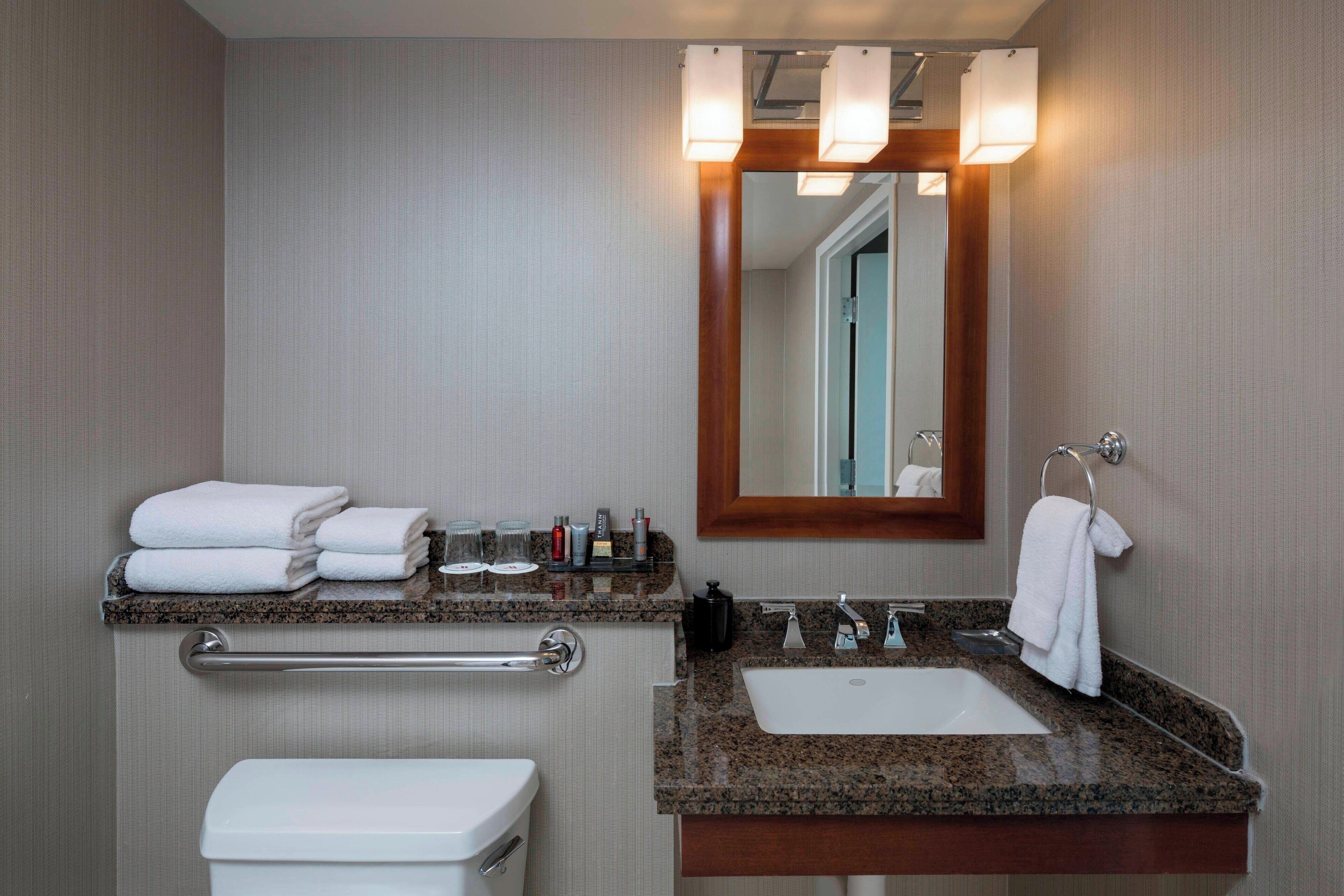 combined shower/bathtub, designer toiletries, hair dryer, towels