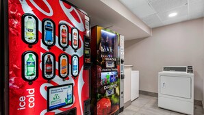 A vending machine with various drink options and a sign promoting plant-based drinks.