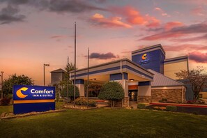 A Comfort Inn & Suites hotel with a modern design, featuring a prominent entrance and a well-maintained outdoor area.