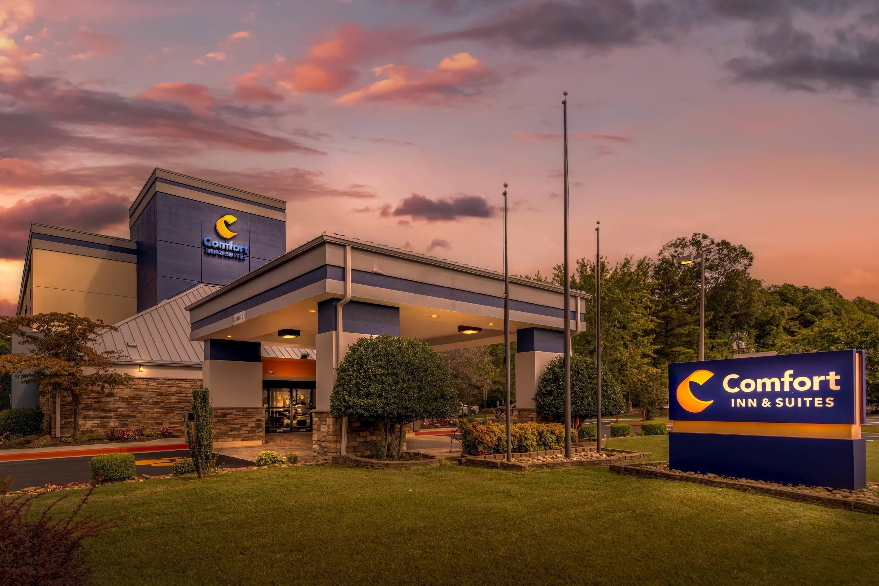 A Comfort Inn & Suites hotel with a modern architectural design, featuring a prominent signage and a well-maintained outdoor area.