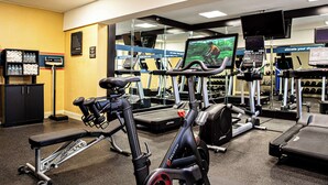 A gym with exercise equipment, a treadmill, and a mirrored wall. - Hampton Inn Charleston-Historic District (Charleston)