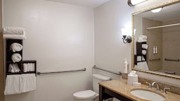 Une salle de bain équipée d’un lavabo, de toilettes et d’un porte-serviettes avec des serviettes.