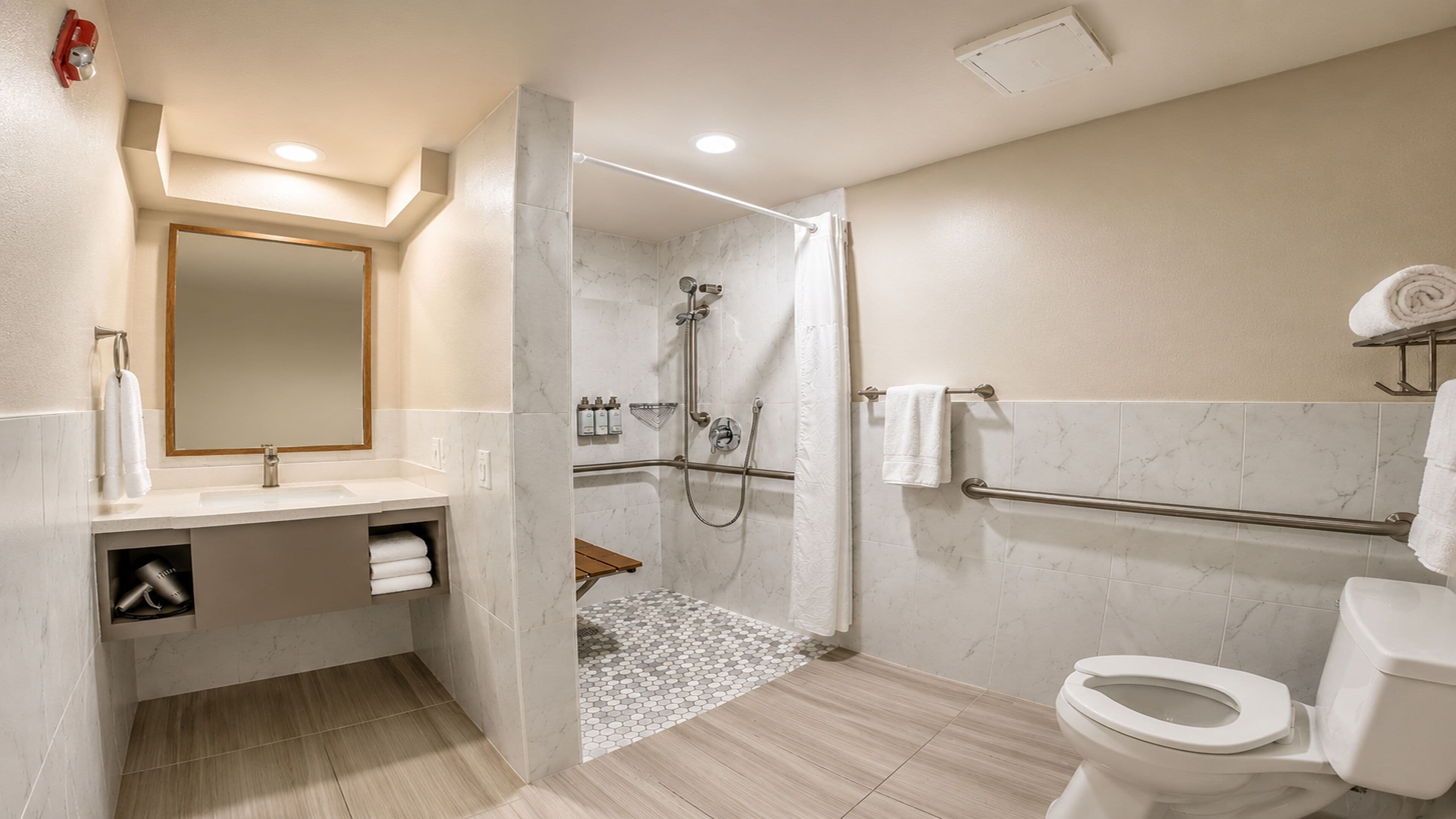 A modern bathroom with a shower, toilet, and sink.