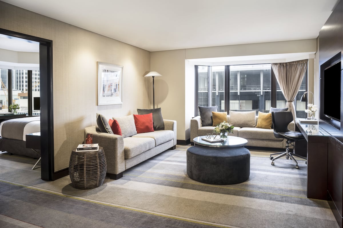 Un salon moderne avec deux canapés, une table basse et un téléviseur.