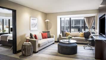 A modern living room with two sofas, a coffee table, and a TV.