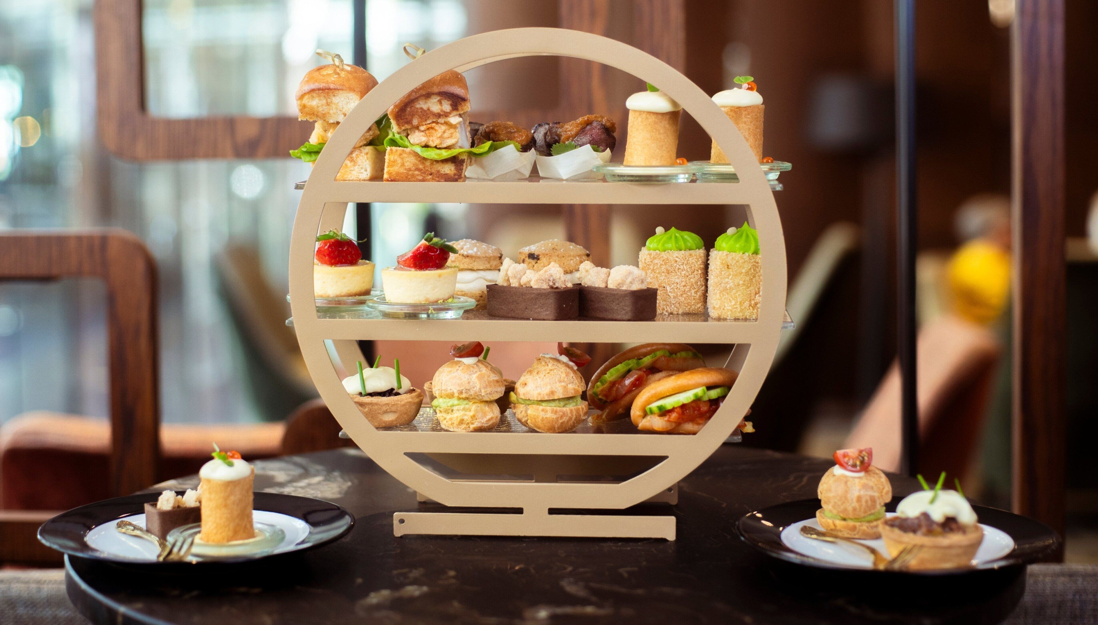 A multi-tiered dessert display with various pastries and desserts.