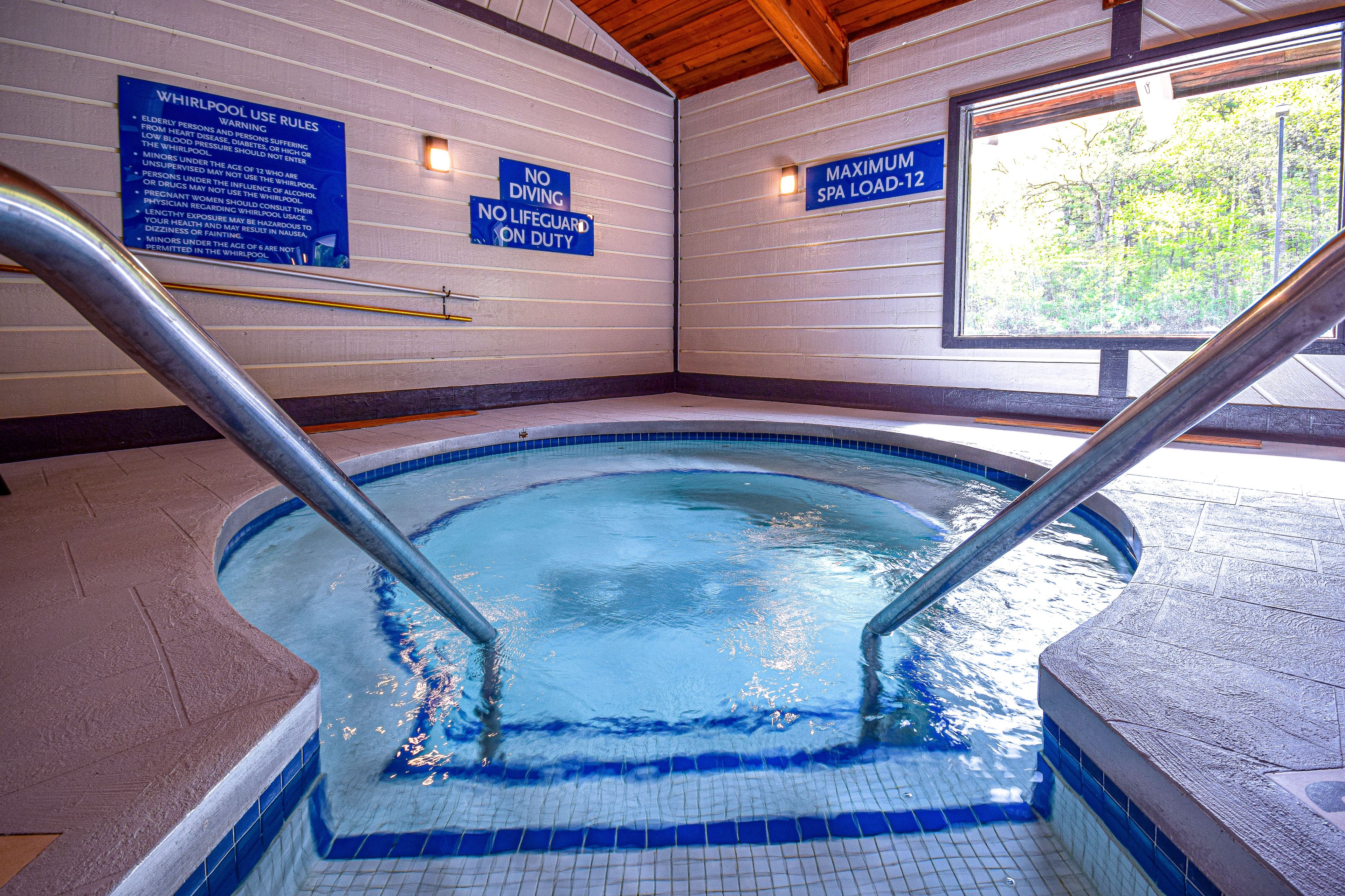 A whirlpool with a sign indicating no diving and no lifeguard on duty.