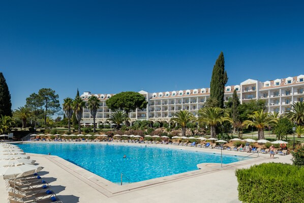Relax by the hotel's large pool surrounded by sun loungers and umbrellas.