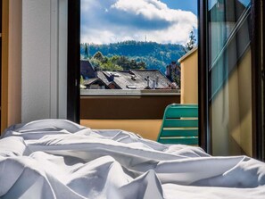 Premium bedding, desk, laptop workspace, blackout drapes