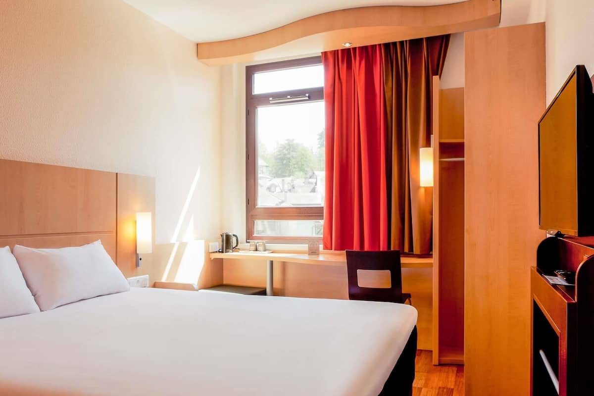 Premium bedding, desk, laptop workspace, blackout drapes