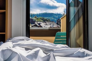 Premium bedding, desk, laptop workspace, blackout drapes