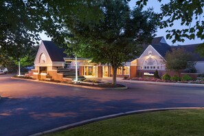 A hotel with a brick facade, a large entrance, and a well-lit driveway. - Hilton Garden Inn Lancaster (Lancaster)
