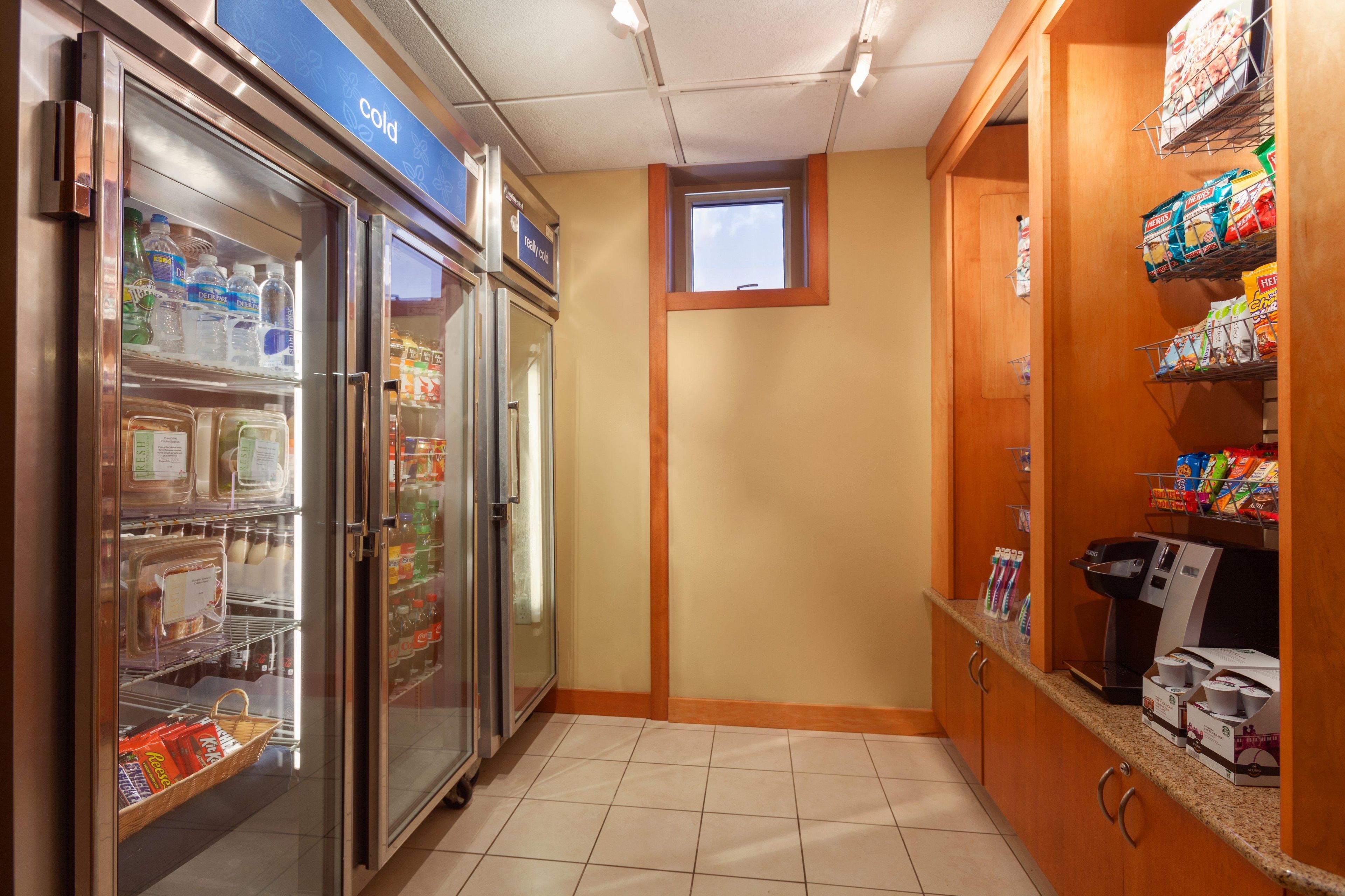 A small kitchenette area with a refrigerator, a microwave, and a coffee maker.