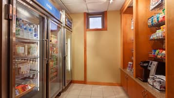 A small kitchenette area with a refrigerator, a microwave, and a coffee maker.