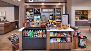 A coffee shop named "The Shop" with a variety of beverages and snacks displayed.