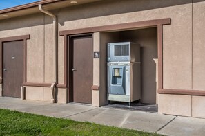 A building with two doors, one labeled "Restrooms" and another with a sign indicating "Ice Cubes."