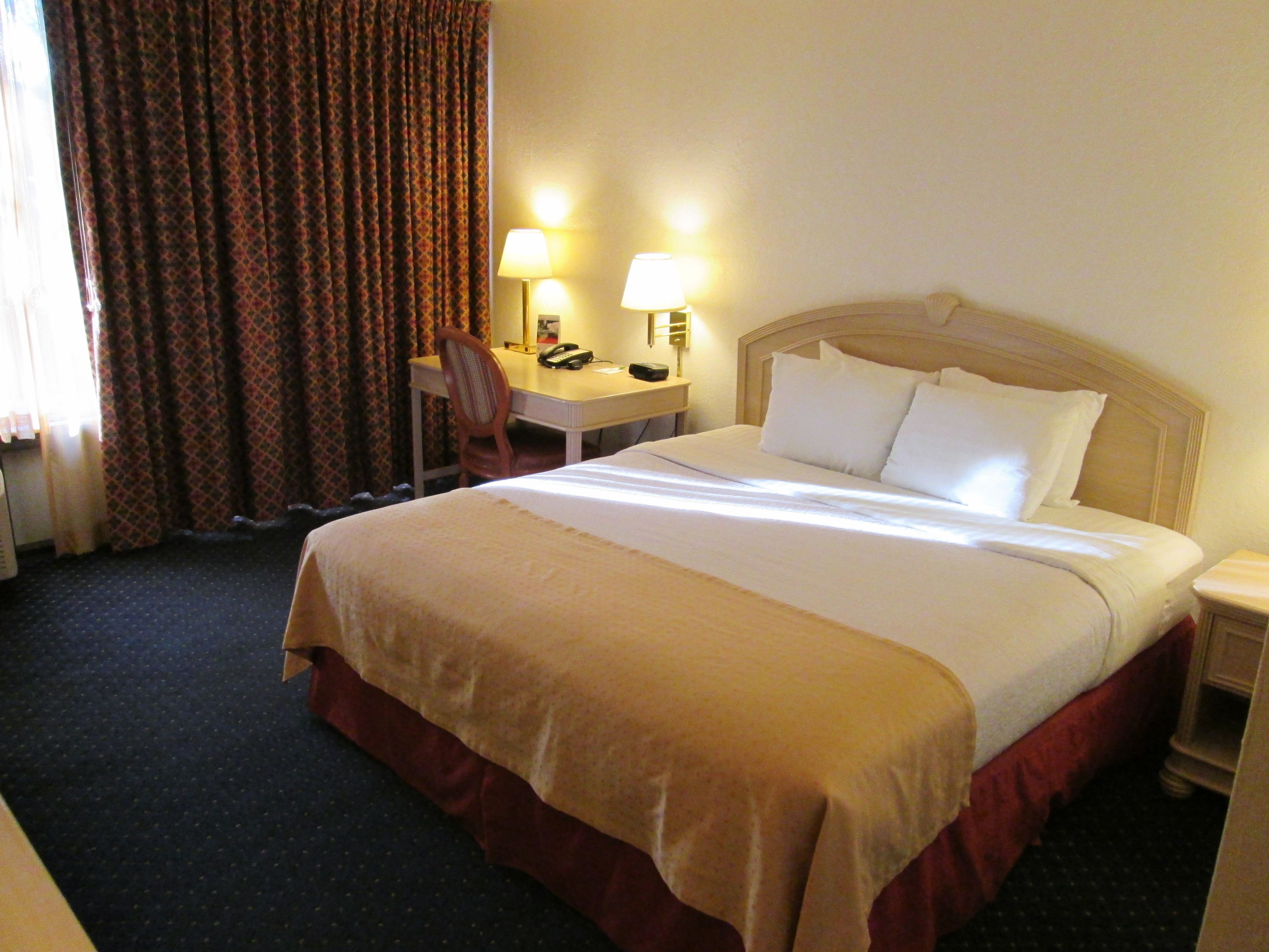 hypo-allergenic bedding, desk, laptop workspace, blackout curtains