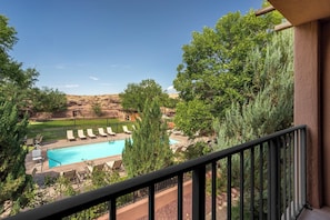 A pool area with lounge chairs and a view of a mountainous landscape. - Holiday Inn Canyon De Chelly by IHG (Chinle)
