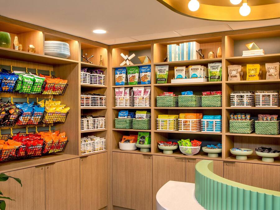 A well-organized pantry with various food items and kitchenware.