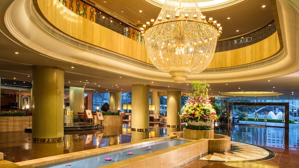 A spacious lobby with a grand chandelier, a central water feature, and a view of the cityscape through large windows. - Sunshine Hotel Shenzhen (Shenzhen)