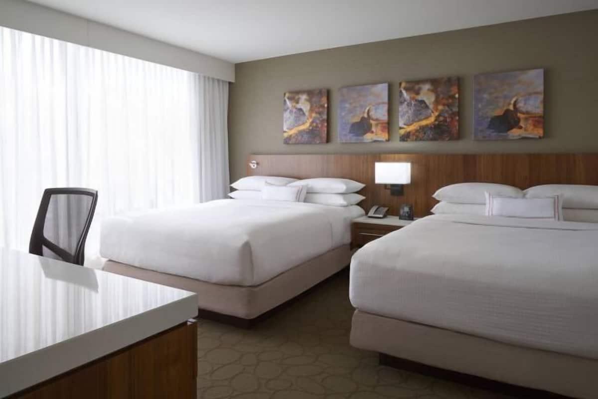 Premium bedding, desk, laptop workspace, blackout drapes