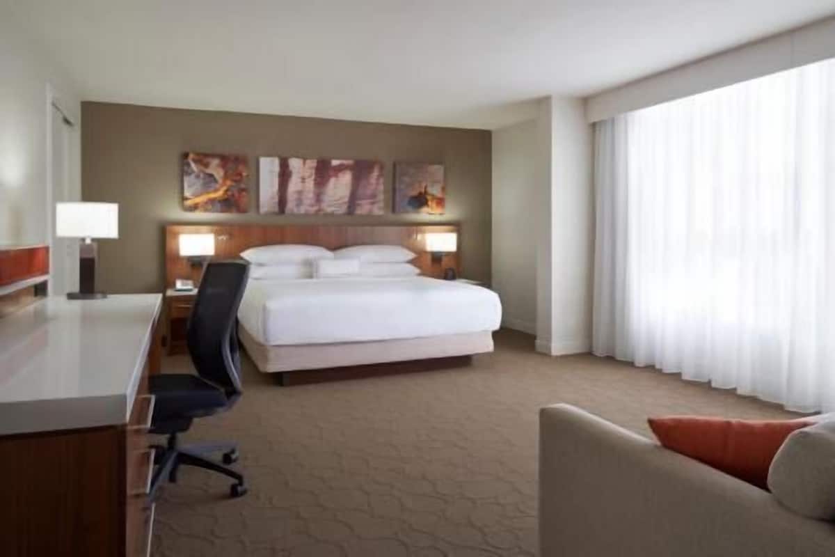 Premium bedding, desk, laptop workspace, blackout drapes