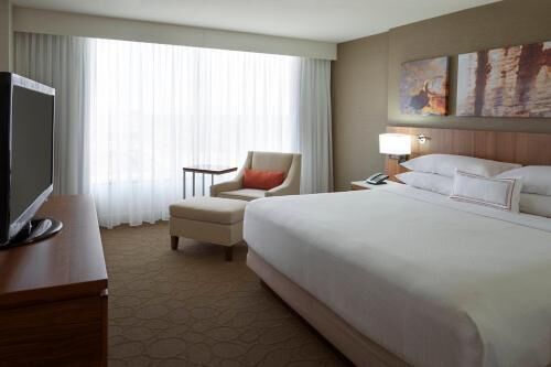 Premium bedding, desk, laptop workspace, blackout drapes