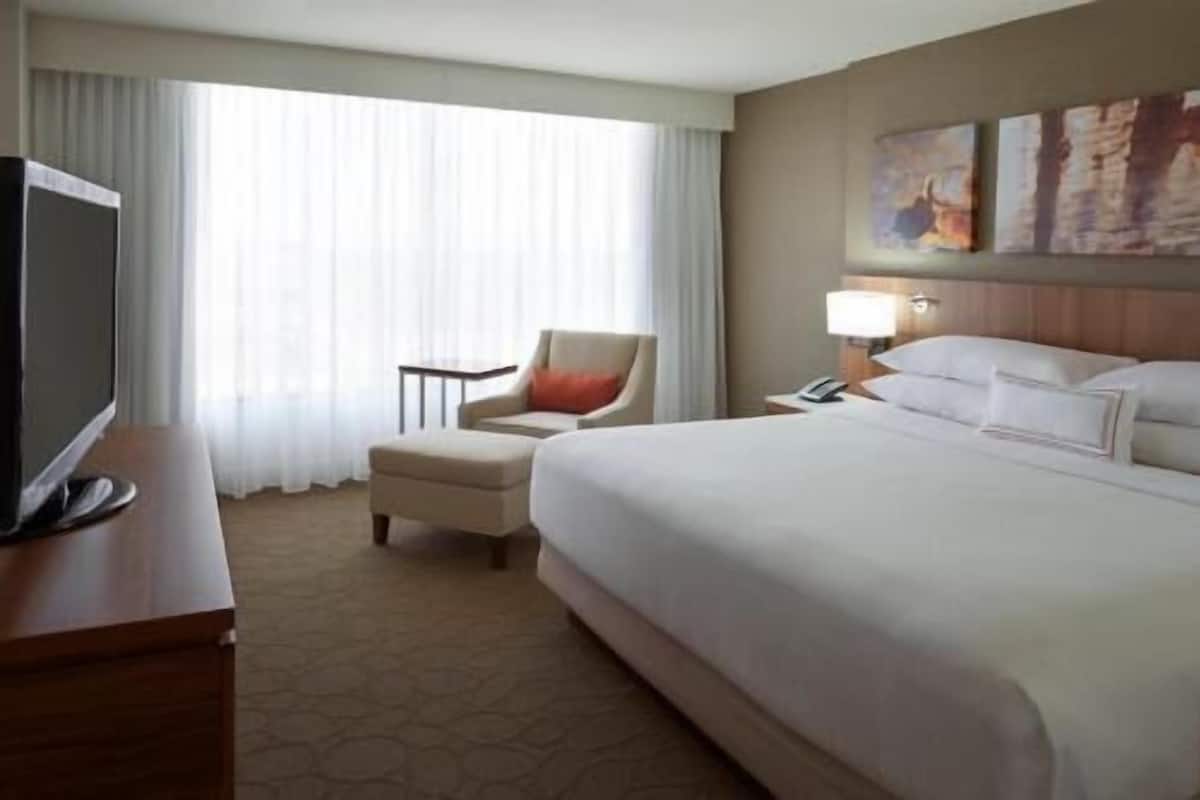 Premium bedding, desk, laptop workspace, blackout drapes