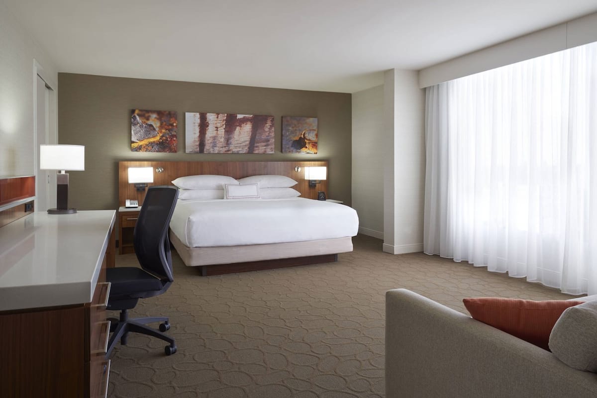 Premium bedding, desk, laptop workspace, blackout drapes