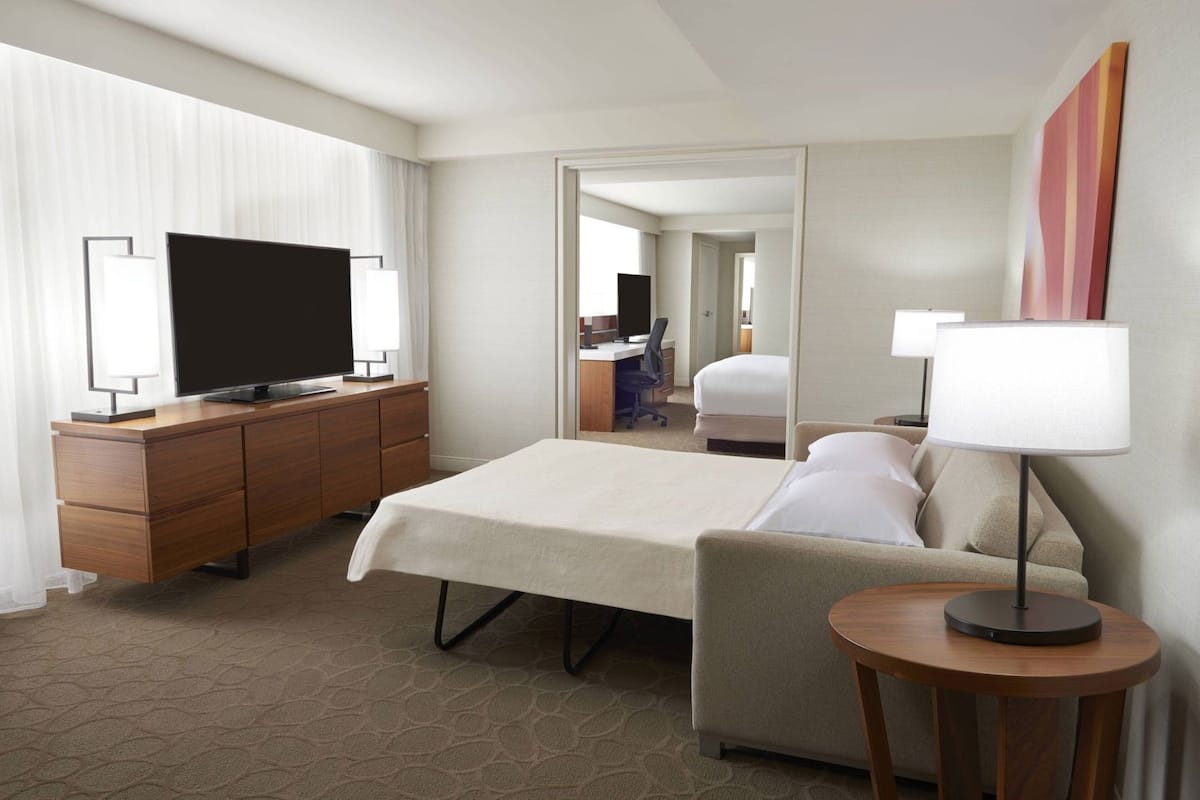 Premium bedding, desk, laptop workspace, blackout drapes