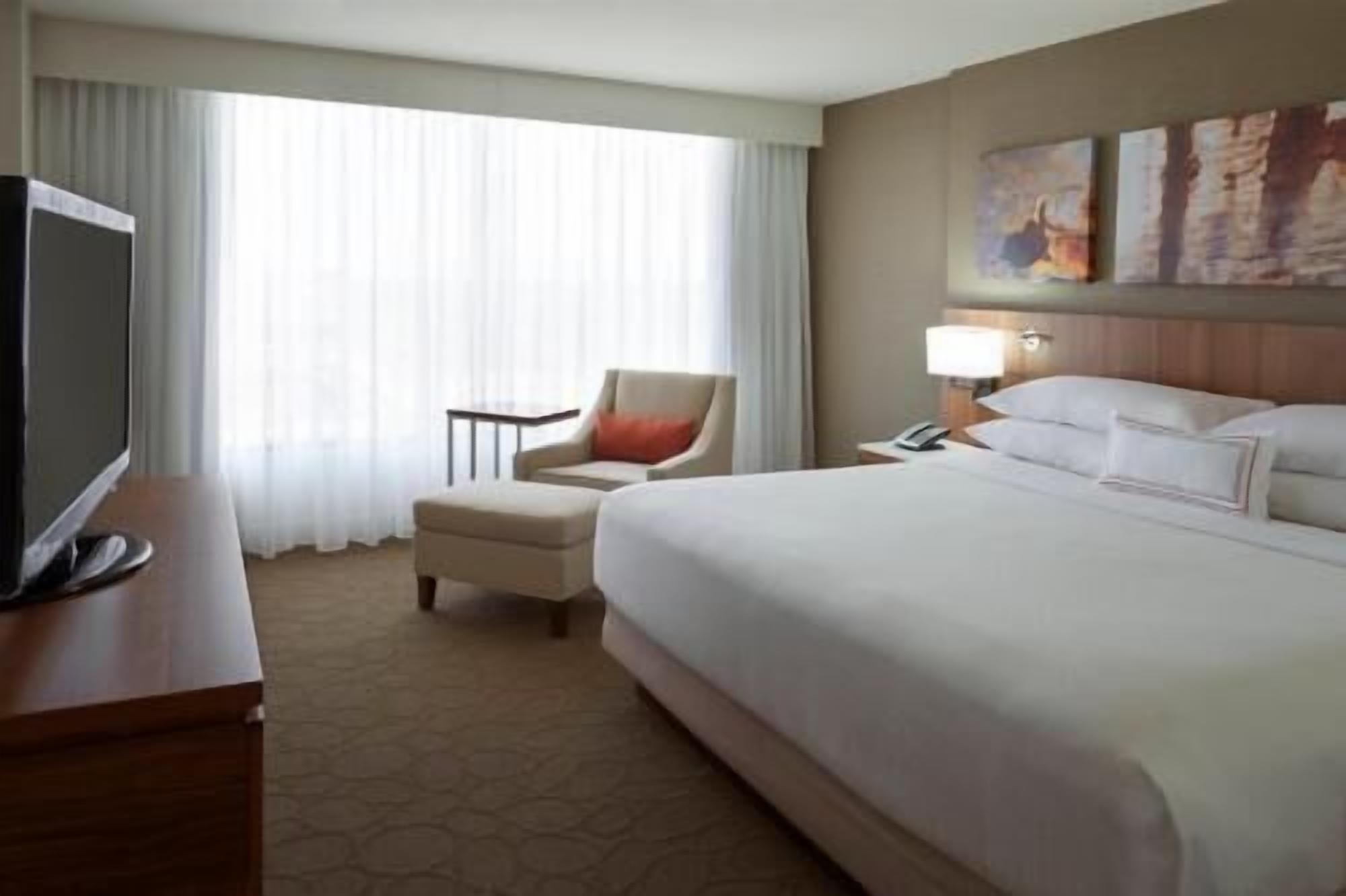 Premium bedding, desk, laptop workspace, blackout drapes