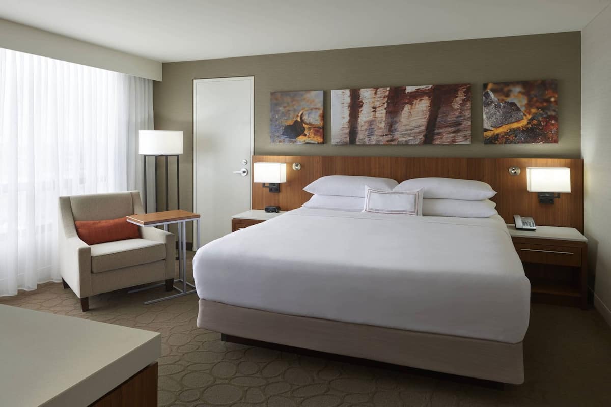 Premium bedding, desk, laptop workspace, blackout drapes
