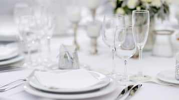 A table set for a formal event with clear glassware, plates, and silverware.