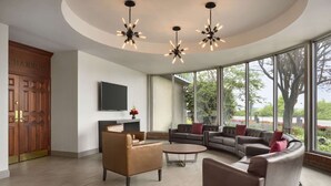 A modern living room with a sectional sofa, a coffee table, and pendant lighting.