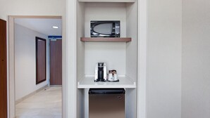 A compact kitchen with a microwave, coffee maker, and dishwasher. - Holiday Inn Express West Los Angeles by IHG (Los Angeles)