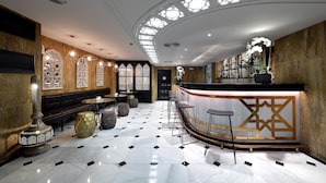 A modern interior with a bar area, seating, and decorative elements.