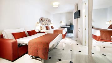 A hotel room with two beds, a desk, and a TV.